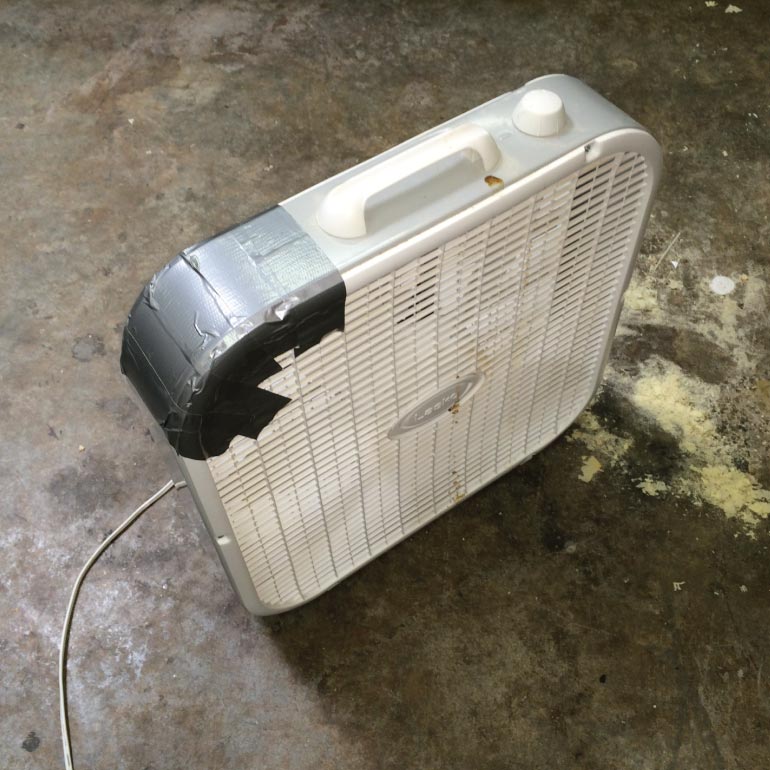 Old Box Fan with Duct Tape on Corner