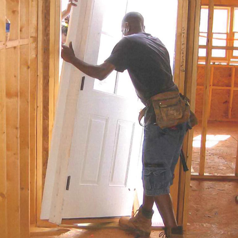 Contractor working to install a door