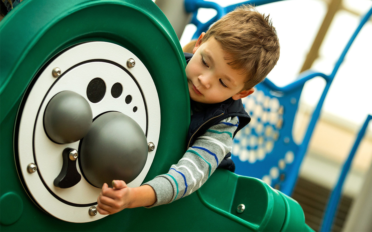 Child Playing On PlayCore Inclusive Playground Equipment