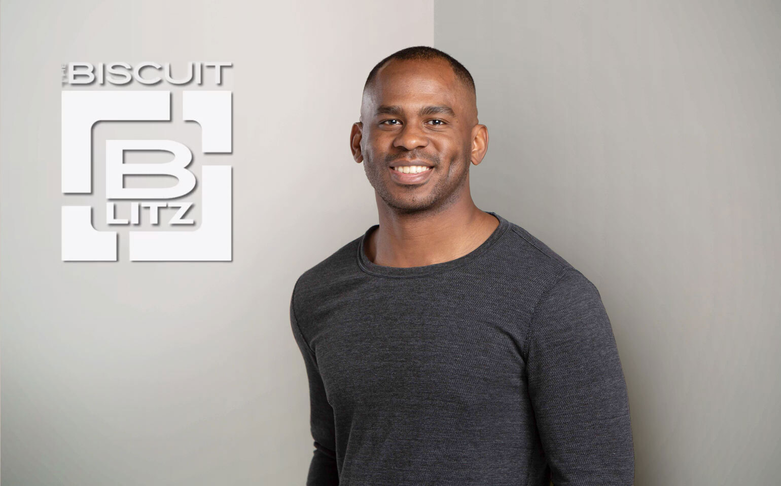 Chris Cureton in front of biscuit blitz logo