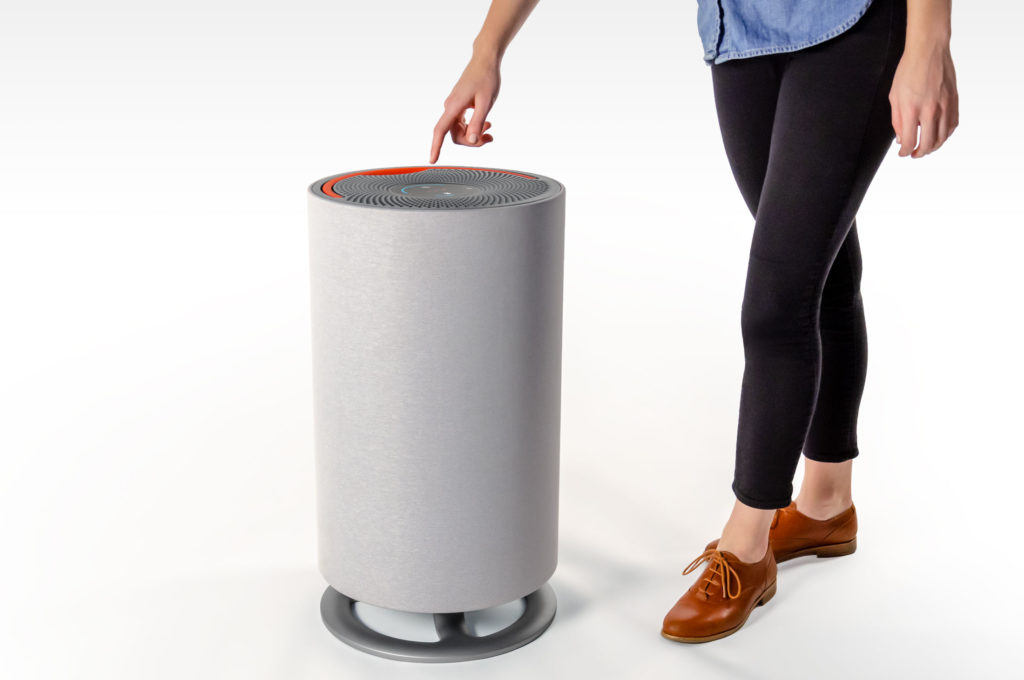 person pressing controls on an Oransi mod air purifier