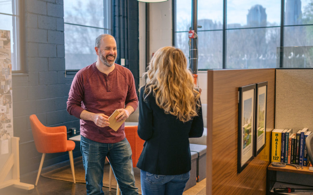 Co-workers talking in an office
