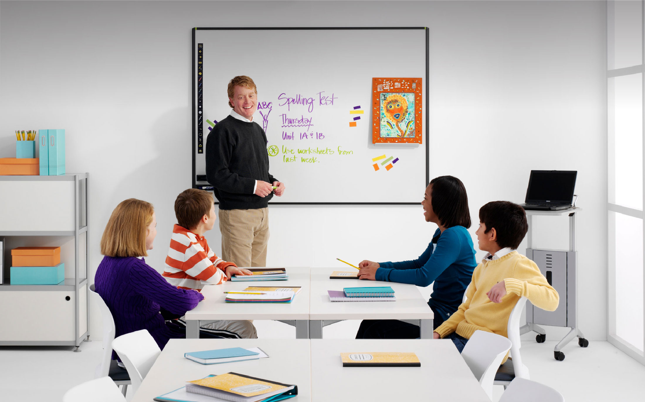 teacher in front of whiteboard in classroom