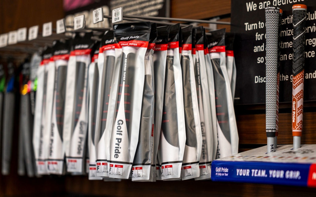 Golf Pride Reverse Taper putter grip in packaging, hanging on pegs in a retail environment