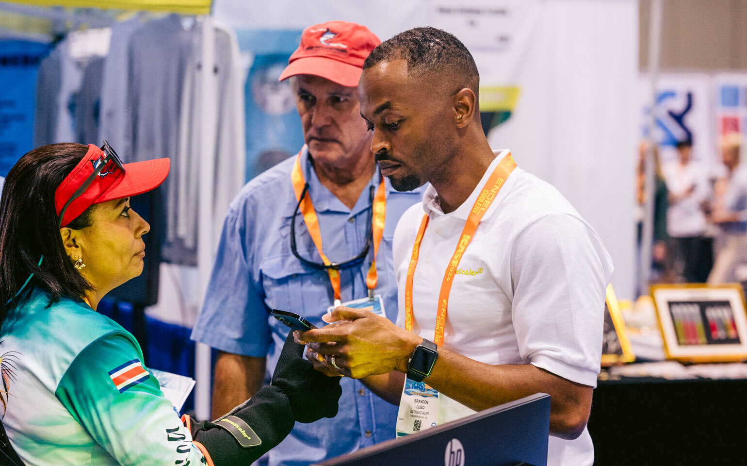 People in Glovescaler booth at ICAST 2024