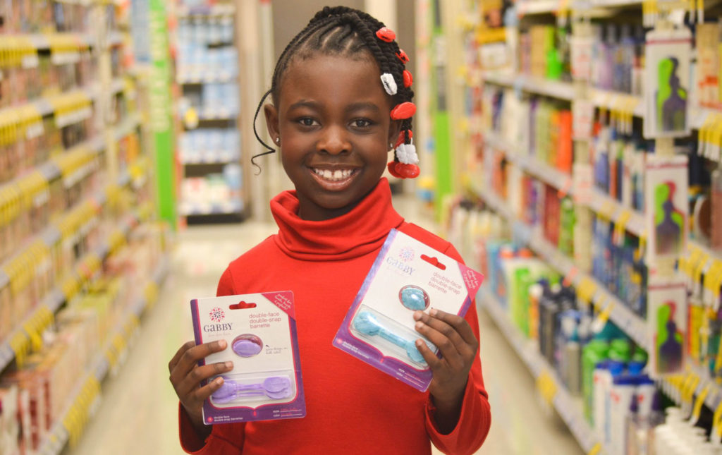 Gabby holding packages of Gabby Bows