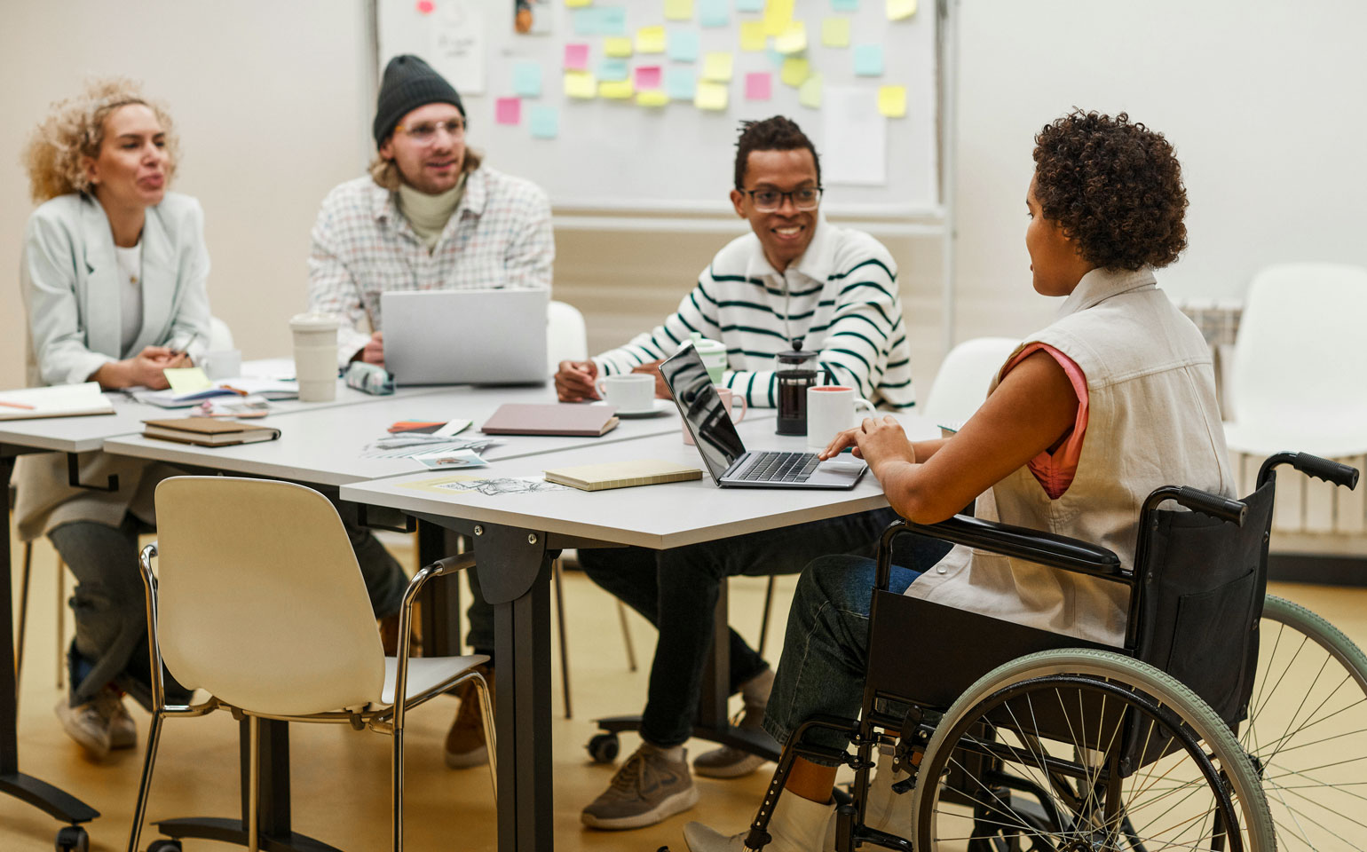 people at table including person in wheelchair