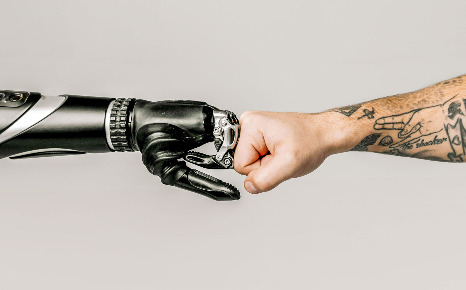 robot hand fist bumping human hand